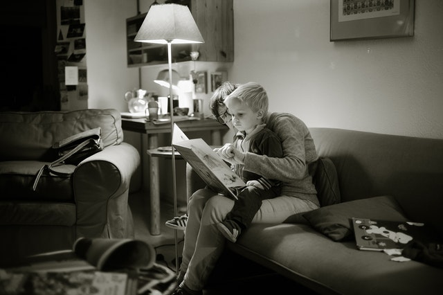 woman reading to child indoors