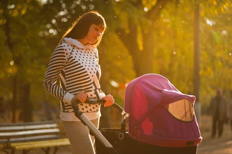 sad mom looking at stroller