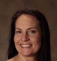 Close up photo of Gretchen Flores in front of brown backdrop