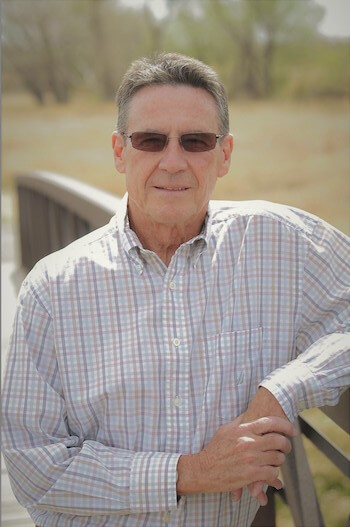 Rick Carter standing outdoors wearing a plaid shirt