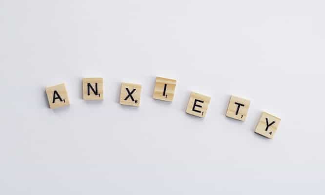 brown wooden scrabble tiles that spell out anxiety