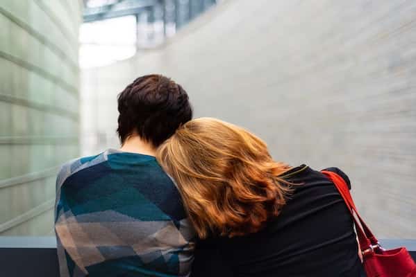 woman resting her head on friend's shoulder