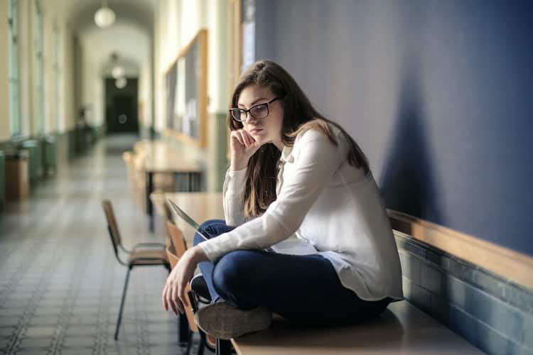 anxious teenager sitting on a couch