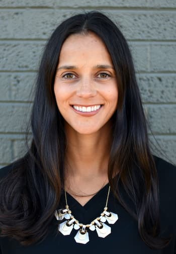 Therapist Tanya Torres outside wearing a dark top and a necklace