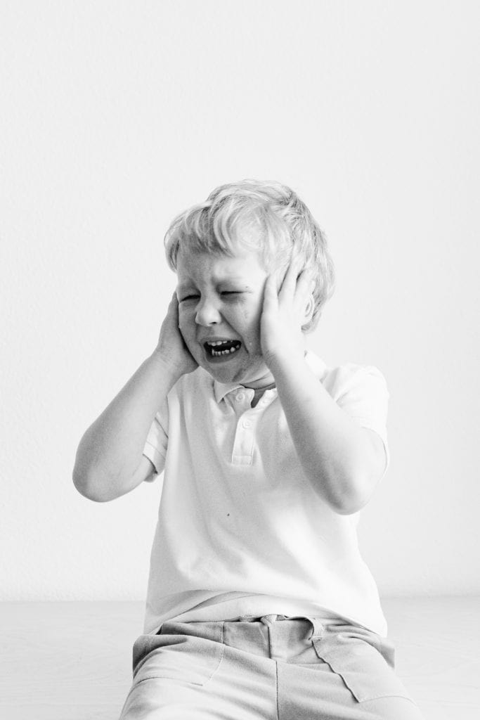 crying kid hands on head