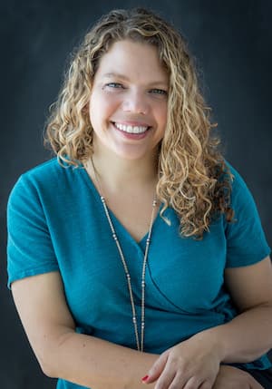 Therapist Rebecca Sacks professional headshot wearing a blue top