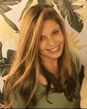 Therapist Erica Krakovitz wearing a green top in front of a patterned wall