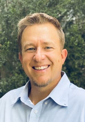 Therapist Erik Petersen outdoors wearing a blue button down shirt