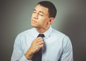 Stressed man fixing his tie