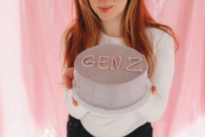girl holding a Gen z cake