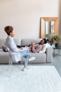 man laying on couch in therapy