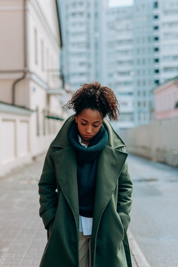 woman walking sad with coat