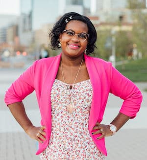 Therapist Mayde Jackson's professional headshot outside wearing a pink top and dress