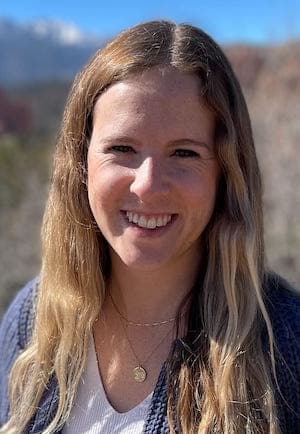 Therapist Caitlyn Conclin outdoors wearing a blue sweater