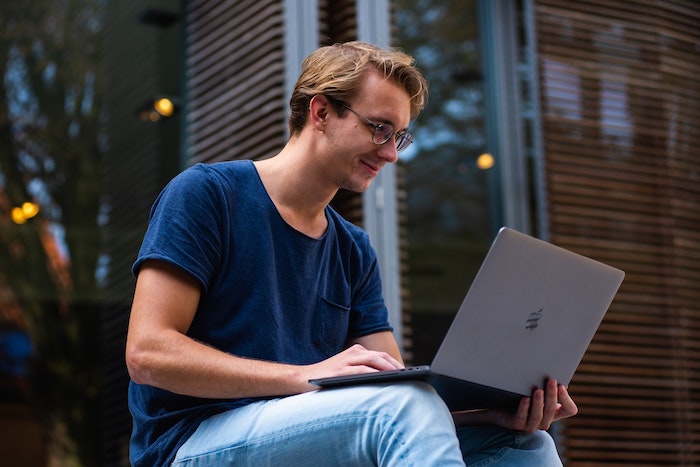 Man smiling at laptop