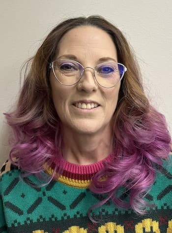 Therapist Neave Halvorson wearing a colorful sweater indoors