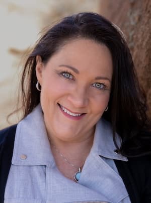 Provider Charla Newcomb's professional headshot outdoors wearing blue top