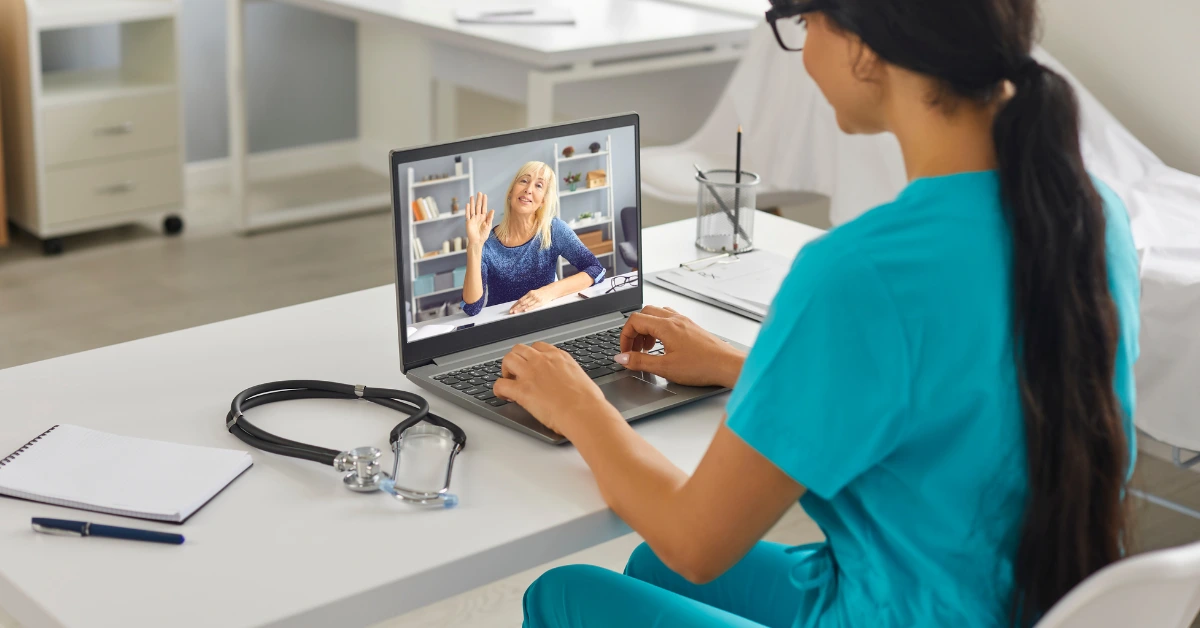 Patient attending an online therapy session with a Denver counselor via laptop